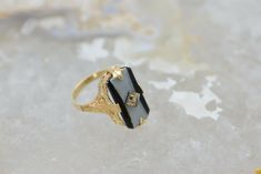 14K Yellow Gold Retro Onyx Filigree Ring, Diamond Center, .75 inch across, white & black stone, Ring size 7, 3.3 grams. Stock # BB101R15 Most rings are sizable for a small fee. If the ring you are considering is the incorrect size contact us for a quote. This listing contains photographs of the actual item you will receive. Our items are in excellent condition with little or no signs of wear and many are one of a kind pre-owned estate finds. Please look closely at the pictures in this listin Black Intaglio Jewelry As A Gift, Art Deco Onyx Ring With Black Enamel, Classic Black Filigree Rings, Black 14k Gold Engraved Jewelry, Engraved 14k Black Gold Jewelry, Engraved Black 14k Gold Jewelry, Art Deco Black Engraved Jewelry, Black Victorian Filigree Ring For Anniversary, Antique Black Filigree Rings