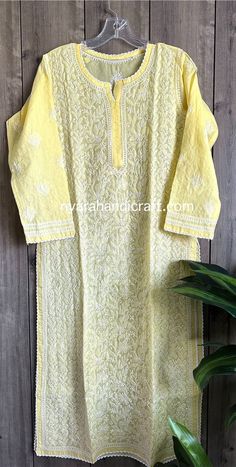 Soft cotton Kurta with matching liner.  Authentic Chikankari hand embroidery.  Kurta length: 46 inches Traditional Yellow Floral Embroidered Kurta, Yellow Straight Kurta With Intricate Embroidery, Yellow Fitted Chikankari Embroidered Fabric, Yellow Cotton Fabric With Chikankari Embroidery, Yellow Kurta With Intricate Embroidery In Chanderi, Yellow Cotton Kurta With Embroidered Border, Yellow Chanderi Kurta With Intricate Embroidery, Yellow Chikankari Embroidered Fabric For Festivals, Traditional Yellow Kurta With Intricate Embroidery