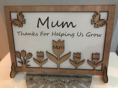 there is a sign that says mum thanks for helping us grow