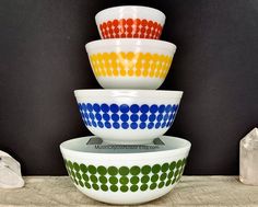 three bowls stacked on top of each other with dots painted on the bottom and sides