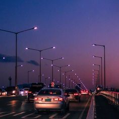 cars are driving on the highway at night