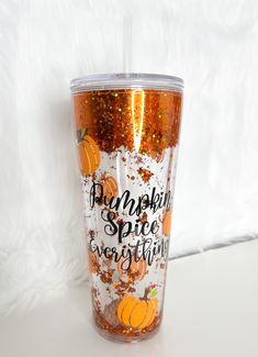 the tumbler cup is decorated with glitter and orange pumpkins, says pumpkin spice everything