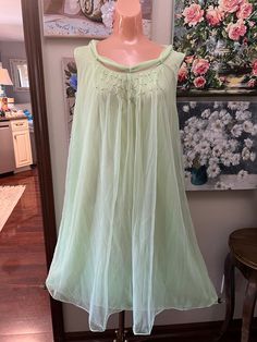 offered is a vintage 60s night gown by Pandora. I believe it to be unworn. It is in pristine condition. Lime green in color it is double nylon layers, the outer being floaty chiffon. The bodice is covered in tiny silver beads. The neckline has a attached scarf which goes through a loop at the back neckline and hangs gracefully. The gown is waltz length. Tagged as size large.  Bust measures 42 " Waist  48" Hips 50" Length from shoulder to hem is 39" Condition is excellent Sheer Nightgown For Wedding Night In Spring, Sheer Evening Sleepwear For Spring, Green Chiffon Dresses For Daywear, Sheer Party Sleepwear For Spring, Green Summer Sleepwear For Wedding Night, Spring Evening Sheer Sleepwear, Sleeveless Summer Evening Nightgown, Spring Chiffon Dresses For Wedding Night, Green Summer Wedding Night Sleepwear