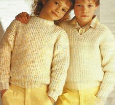 two young children wearing sweaters and yellow pants in front of a white background with the caption