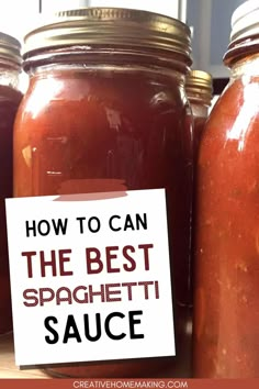 some jars filled with red sauce and a sign that says how to can the best spaghetti sauce