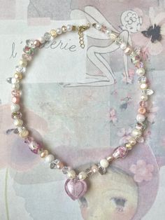 super cute fairycore inspired baby pink heart necklace ️🌸 made with murano glass heart pendant, fresh water pearl beads and rondelle crystals beads <3 necklace is approximately 16 inches but has a chain at the end to adjust length!  Canadian Orders 🇨🇦  this order is eligible for free shipping through untracked lettermail however I cannot refund/replace lost or stolen items with no tracking number due to Etsy's policies, so please keep that in mind when selecting free shipping. thank you! Cheap Beaded Heart Necklace, Cute White Heart-shaped Beaded Necklace, Cute Pearl Jewelry With Heart Beads, Pink Y2k Jewelry As Gift, Cute Pink Pearl Necklace, Y2k Style Round Beads Jewelry Gift, Y2k Style Round Beads Jewelry As Gift, Y2k Style Round Bead Jewelry For Gifts, Y2k Pink Beaded Necklaces