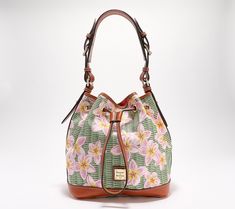 Covered in a fresh, floral design, this coated cotton drawstring bag feels just right for spring. Sling it over your shoulder as you step out into the sunshine -- an adjustable handle allows for comfortable positioning. From Dooney & Bourke. Casual Floral Print Bags For Spring, Green Bucket Bag With Adjustable Strap For Spring, Spring Bucket Bag With Adjustable Strap For Daily Use, Spring Travel Bucket Bag With Adjustable Strap, Casual Multicolor Bucket Bag For Spring, Spring Green Bucket Bag With Adjustable Strap, Multicolor Bucket Bag With Adjustable Strap For Spring, Multicolor Bucket Bag For Spring, Green Bucket Bag For Everyday Spring Use