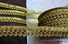 two rolls of gold colored thread on top of each other