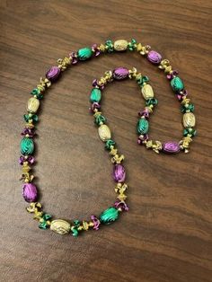 a beaded necklace on a wooden table