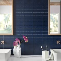 a bathroom with two sinks, mirrors and vases on the counter next to each other