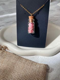 ✨Handmade Rhodochrosite crystal chip bottle pendants (approximately 3cms), crafted from high quality natural Rhodochrosite and stainless steel, perfect sensitive skins. Tarnish resistant jewellery that will last a lifetime ✨ (Bottle cork is secure and not removable) 💕Rhodochrosite: Known as the Rose Stone, activates the Heart Chakra and is a healing stone of compassion, love and self-awareness. Rhodochrosite is made up primarily of manganese and carbon, adding energies of balance and purificati Rhodochrosite Crystal, Summer Jewellery, Rose Stone, Precious Gemstones Jewelry, Bottle Corks, Feel Loved, Bottle Necklace, Necklace Unique, Gemstone Jewellery