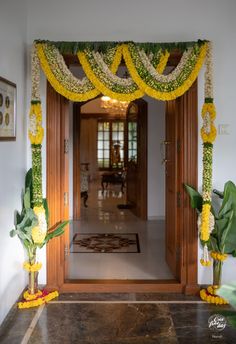 an entrance decorated with flowers and greenery