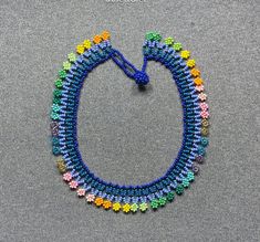 This beautiful beaded necklace is hand-woven by the women of the Embera Chami Indigenous Tribe of Colombia Bohemian Choker With Bead Caps For Gift, Hand-strung Beaded Necklaces For Festivals, Bohemian Choker With Round Beads And Bead Caps, Adjustable Multicolor Beaded Necklaces With Bead Caps, Traditional Adjustable Beaded Necklaces With Bead Caps, Traditional Adjustable Necklace With Bead Caps, Adjustable Beaded Choker With Bead Caps, Handwoven Beaded Necklace For Festival, Traditional Handwoven Beaded Necklaces For Festivals