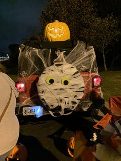 a car decorated for halloween with pumpkins on top