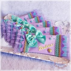 there are many purple and blue bags with bows on the top one is for barbie