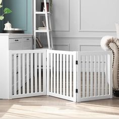 a white baby crib in the corner of a room next to a book shelf