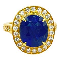 This is part of Chairish’s Fine Jewelry assortment.  GIA 9.45 ct. Sri Lanka blue sapphire oval with good quality white diamond rounds.  Handmade in 18k yellow gold.  Ring size 7.  GIA certificate included. Luxury Yellow Gold Gia-certified Sapphire Ring, Luxury Gia Certified Yellow Gold Sapphire Ring, Gia Certified Oval Gold Sapphire Ring, Gia Certified Gold Sapphire Ring, Gia Certified Gold Sapphire Ring For Formal Occasions, Formal Gold Sapphire Ring Gia Certified, Purple Cocktails, Sapphire Cocktail Ring, Gia Certificate