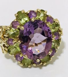 Oval Multi-stone Peridot Gemstones, Luxury Multicolor Amethyst Ring With Gemstone Accents, Multicolor Luxury Amethyst Ring, Multicolor Oval Amethyst Ring, Multicolor Oval Amethyst Ring With Gemstone Accents, Multicolor Elegant Amethyst Ring, Luxury Multicolor Amethyst Gemstones, Multicolor Oval Amethyst Ring With Accent Stones, Oval Multi-stone Amethyst Gemstones