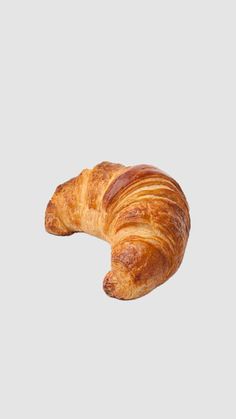 a croissant sitting on top of a white surface