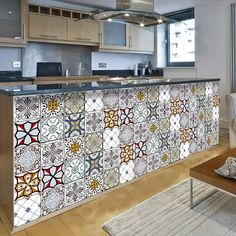 a kitchen with an island covered in colorful tiles