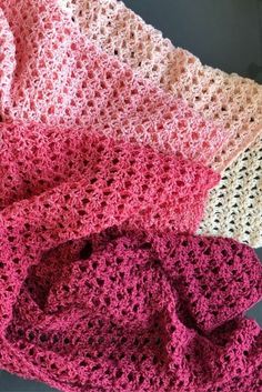 three crocheted blankets sitting next to each other