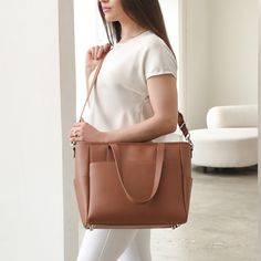 This structured tote is the ultimate do-it-all bag that you deserve. It's the perfect carryall for work, travel, and anywhere your day brings you. It features a spacious and organized interior for your essentials, a padded compartment for your laptop, side pockets for your drinks, and you can convert it into a backpack or crossbody. Crafted from premium American Saffiano leather that's waterproof and scratch-resistant, the Transform Tote will stay just as beautiful through all your travels and a Modern Weekender Bag With Removable Pouch For On-the-go, Luxury Cognac Laptop Bag For Everyday, Cognac Weekender Bag With Luggage Sleeve For Everyday, Everyday Cognac Weekender Bag With Luggage Sleeve, Elegant Cognac Laptop Bag For Everyday Use, Chic Brown Laptop Bag For Travel, Cognac Tote Weekender Bag For Travel, Everyday Cognac Briefcase With Luggage Sleeve, Versatile Brown Briefcase For Everyday Use