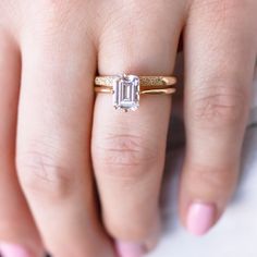 a woman's hand with a ring on it and a diamond in the middle