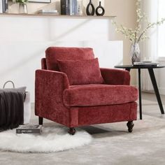 a red chair sitting on top of a white rug