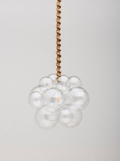 a chandelier hanging from a ceiling with glass balls in the shape of flowers