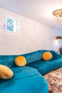 a blue couch sitting in the middle of a living room