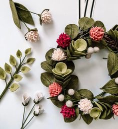 the wreath is made with felt flowers and leaves