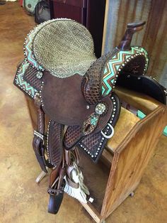 a saddle sits on top of a wooden stand