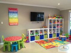 a child's playroom with toys, bookshelves and colorful rugs