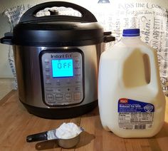 a jug of milk next to an instant pot and a digital clock