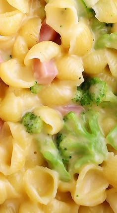 a close up view of macaroni and cheese with broccoli