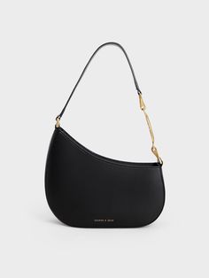 Featuring a sleek and sophisticated sculptural silhouette, our asymmetrical shoulder bag offers dawn-to-dusk versatility. With a black finish that will complement everything in your wardrobe, this gem will go with any ensemble you choose to wear. Adorned with a chic chain and bag strap, style this bag with an asymmetric skirt and a batwing blouse for an elegant workwear look. Elegant Workwear, Mix Match Outfits, Chic Crossbody Bag, Batwing Blouse, Slouchy Bag, Asymmetric Skirt, Faux Leather Bag, Classic Handbags, Bags Shop