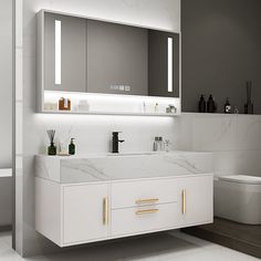 a modern bathroom with marble counter tops and white cabinets