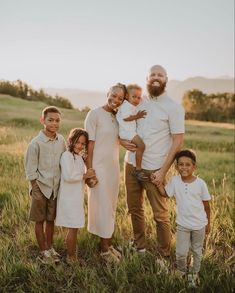 a family poses for a photo in a field