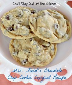 three chocolate chip cookies on a plate with the words, can't stay out of the kitchen