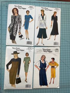 four different styles of women's dress and jacket sewing patterns on a cutting board