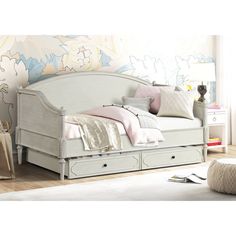 a white day bed with drawers underneath it