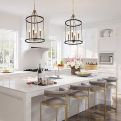 a large kitchen with white cabinets and counter tops, an island with four stools