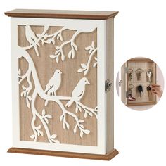 a wooden box with two birds on it and key holders in the bottom right corner