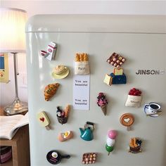 a refrigerator with magnets on the front and bottom door is covered in magnets