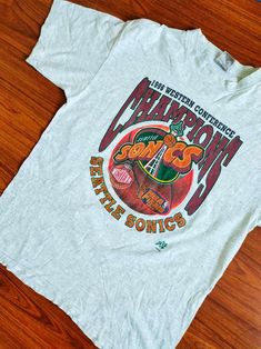 Vintage Seattle Sonics NBA Finals 90's Shirt Streetwear Collared Shirt, Cheap Jersey College T-shirt, Cheap Pop Culture Graphic T-shirt, Vintage Championship Tee, Vintage Mlb Shirt, Cheap 90s Style Sports T-shirt, Cheap 90s Sports T-shirt, 90s Style Graphic Design, Vintage Nba Shirt