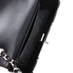 This mini Rectangular flap bag is of black and silver printed lambskin leather with ruthenium tone hardware and has a front flap with signature CC turnlock closure, rear half moon pocket, single interwoven black leather and ruthenium tone chain link shoulder/crossbody strap.The interior is lined in black leather and features a zipper pocket with Chanel pull and an open pocket below.Collection: 22C (RFID Chip)Origin: FranceCondition: New and never worn (plastic on hardware)Accompanied by: Chanel box, Chanel dustbag, felt, RFID, retail UPCMeasurements: 8" width x 5" height x 2.5" depth; 22.5" strap drop Designer Black Rectangular Flap Bag, Luxury Black Flap Bag With Rectangular Case, Luxury Black Flap Bag Rectangular Case, Luxury Black Rectangular Flap Bag, Evening Flap Bag With Palladium Hardware, Black Flap Bag With Branded Hardware For Business, Black Double Flap Bag For Office, Black Double Flap Office Bag, Luxury Flap Bag With Silver-tone Hardware For Business