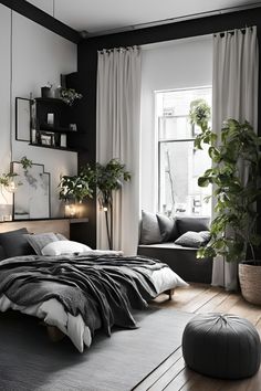 a bedroom with black and white walls, wooden flooring and large bed in front of a window