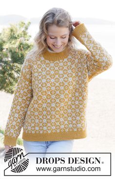 a woman wearing a yellow and white sweater