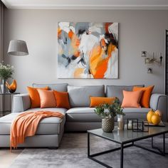 a living room with grey couches, orange pillows and a painting on the wall