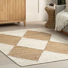 a beige and white rug on the floor next to a couch in a living room